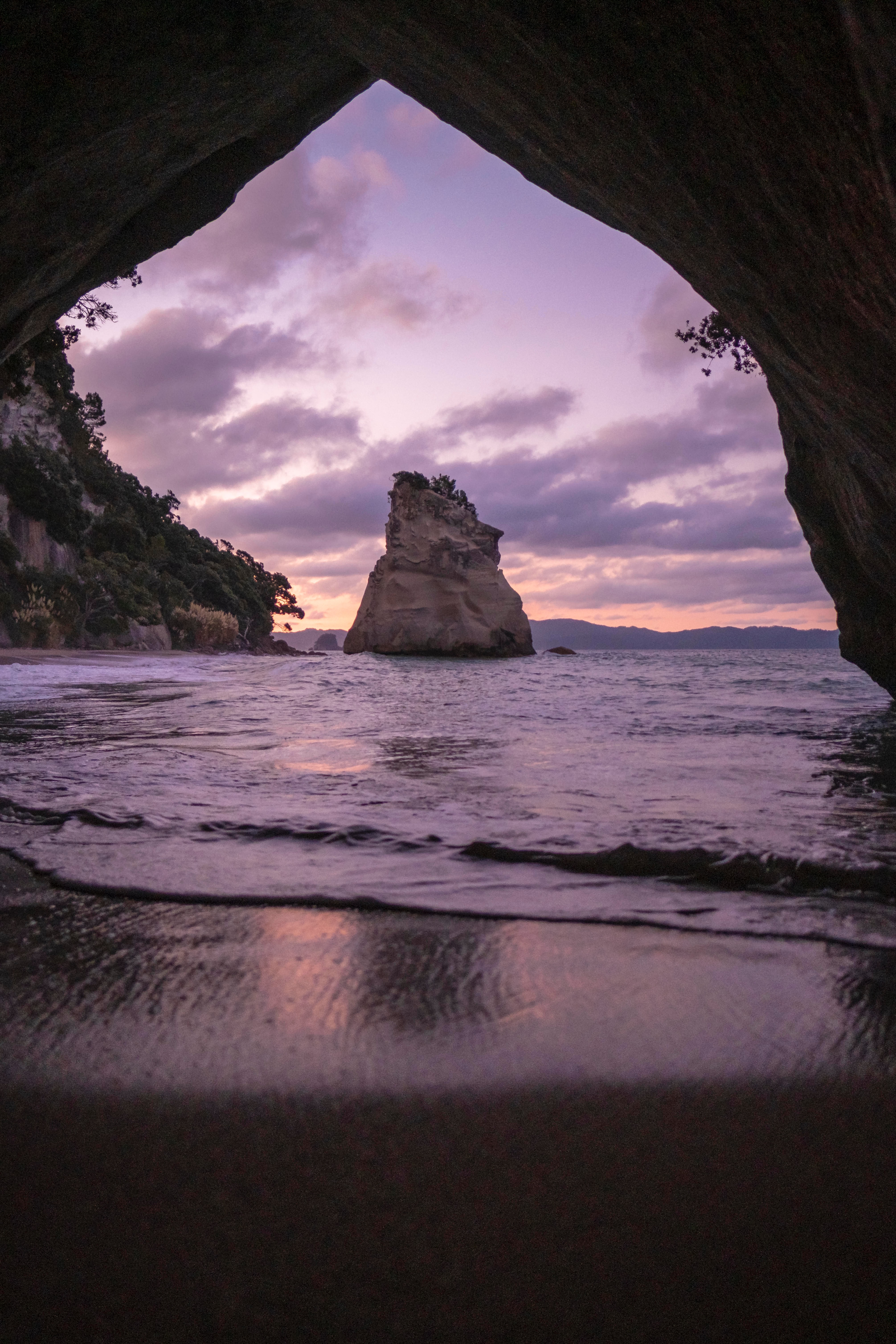 Sacred natural landscape, cave opening to ocean at dusk